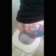 A woman with a floral pattern tattoo on her ass records herself from a rear perspective as she takes a massive shit while sitting on a toilet. She wipes her ass when done. Presented in 720P vertical HD format. Over 2 minutes.